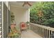 Cozy deck with two chairs, potted plants, and view of lush trees at 226 Mclaren Gates Dr, Marietta, GA 30060