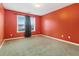 Spacious bedroom with orange walls and neutral carpeting at 4911 Crinklepoint Ct, Douglasville, GA 30134