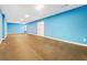 Spacious finished basement with light blue walls at 4911 Crinklepoint Ct, Douglasville, GA 30134