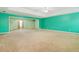 Main bedroom with teal walls, carpeting and sitting area at 4911 Crinklepoint Ct, Douglasville, GA 30134