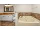 Bathroom boasts double sinks, granite counters, and a relaxing garden tub at 4027 Evelyn Dr, Powder Springs, GA 30127