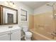 Bathroom with beige bathtub and shower, white vanity, and tile flooring at 4027 Evelyn Dr, Powder Springs, GA 30127