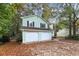Light green house with a three-car garage at 4027 Evelyn Dr, Powder Springs, GA 30127