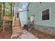 House exterior showcasing a deck, stairs, and landscaping at 4027 Evelyn Dr, Powder Springs, GA 30127