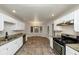 Open kitchen with granite countertops, stainless steel appliances, and breakfast nook at 4027 Evelyn Dr, Powder Springs, GA 30127