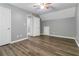 Bedroom with wood-look floors, gray walls, and ceiling fan at 310 Overbend Sw Lndg, Marietta, GA 30008