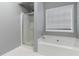 Bathroom with soaking tub, shower, and gray walls at 310 Overbend Sw Lndg, Marietta, GA 30008