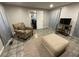 Living room with tiled floor, comfy chair, and ottoman at 3759 Stanford Cir, Decatur, GA 30034
