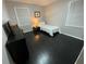 Small bedroom with dark hardwood floors and a twin bed at 3759 Stanford Cir, Decatur, GA 30034