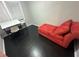 Small office with dark hardwood floors, a desk, and a red chaise lounge at 3759 Stanford Cir, Decatur, GA 30034