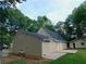Tan house with a back patio, grassy yard, and AC unit at 99 Libby Ln, Jonesboro, GA 30238