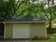 Detached single car garage with white door and light taupe siding at 99 Libby Ln, Jonesboro, GA 30238