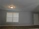 Living room with grey walls, wood-look flooring, and window at 99 Libby Ln, Jonesboro, GA 30238
