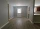 Dining area with grey walls, wood-look flooring, and access to kitchen at 99 Libby Ln, Jonesboro, GA 30238