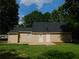 Tan house with a back patio and grassy yard at 99 Libby Ln, Jonesboro, GA 30238