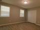 Spacious bedroom with wood-look flooring and ample closet space at 99 Libby Ln, Jonesboro, GA 30238