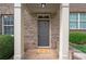 Inviting entryway with a gray door and brick exterior at 3910 High Dove Sw Way, Smyrna, GA 30082