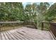 Wooden deck overlooks a wooded backyard with steps leading down at 2791 Willow Tree Overlook, Douglasville, GA 30315