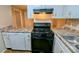 Kitchen area with white cabinets and gas range at 5453 Deerfield Trl, Atlanta, GA 30349