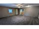 Spacious living room with carpet and exposed brick at 5453 Deerfield Trl, Atlanta, GA 30349