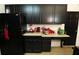 Kitchen with black cabinets and red accents at 4755 Stonecrop Dr, South Fulton, GA 30349