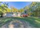 Large backyard with a wooden deck and mature trees at 160 Cross Creek Pkwy, Dallas, GA 30157