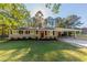 Ranch home with red door and landscaped lawn at 160 Cross Creek Pkwy, Dallas, GA 30157