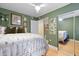Bedroom with green walls, ceiling fan, and mirrored closet doors at 387 Ralph Mcgill Ne Blvd # K, Atlanta, GA 30312