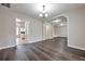 Open dining room with hardwood floors, leading to kitchen and stairs at 5941 S Deshon Ct, Lithonia, GA 30058