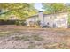 Back of house view, showcasing a deck and spacious yard with mature trees at 3730 Douglas Ridge Trl, Douglasville, GA 30135