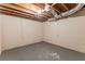 Unfinished basement with concrete floor and exposed beams at 3730 Douglas Ridge Trl, Douglasville, GA 30135