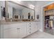 Double vanity bathroom with granite countertop and walk-in closet at 55 River Meadow Ln, Social Circle, GA 30025