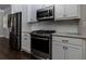 Modern kitchen with stainless steel appliances and white cabinetry at 322 Little Pine Ln, Woodstock, GA 30188