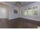 Light-filled living area with hardwood floors and French doors at 322 Little Pine Ln, Woodstock, GA 30188