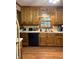 Kitchen with wood cabinets, laminate floor, and modern appliances at 2111 Hutton Dr, Grayson, GA 30017