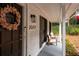 Covered porch with seating and fall wreath on front door at 2377 Emory Ln, Marietta, GA 30068