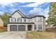 Two-story house with three-car garage and landscaped lawn at 1411 Splitrock Sw Pl, Atlanta, GA 30331