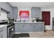 Galley kitchen with gray cabinets, white subway tile, and stainless steel appliances at 2611 Kings Cir, Lawrenceville, GA 30044