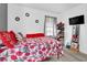 Well-lit bedroom with a queen bed, red bedding and ample closet space at 2611 Kings Cir, Lawrenceville, GA 30044