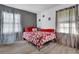 Charming bedroom with a queen bed and floral bedding, offering ample natural light at 2611 Kings Cir, Lawrenceville, GA 30044