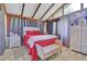 Bright bedroom with a red bed and large windows at 2611 Kings Cir, Lawrenceville, GA 30044