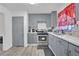 Gray kitchen cabinets, stainless steel appliances, and a view of the dining area at 2611 Kings Cir, Lawrenceville, GA 30044