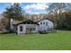 Home's rear view with a large backyard at 2611 Kings Cir, Lawrenceville, GA 30044