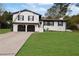 Brick ranch home with 2-car garage, landscaped lawn, and large driveway at 2611 Kings Cir, Lawrenceville, GA 30044