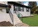 White brick entryway with black railings and a welcome mat at 2611 Kings Cir, Lawrenceville, GA 30044