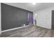 Simple bedroom with grey accent wall, hardwood floors and ample natural light at 2611 Kings Cir, Lawrenceville, GA 30044