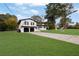 White brick house with a two-car garage and a large front yard at 2611 Kings Cir, Lawrenceville, GA 30044