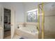 Bathroom with garden tub, shower, and stained glass window at 2194 Ne Indian Shoals Dr, Loganville, GA 30052