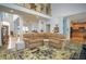 Open living room with hardwood floors, sectional sofa and access to kitchen at 2194 Ne Indian Shoals Dr, Loganville, GA 30052