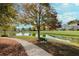 Serene lake with walking path and benches at 6150 Pristine Dr, Cumming, GA 30040